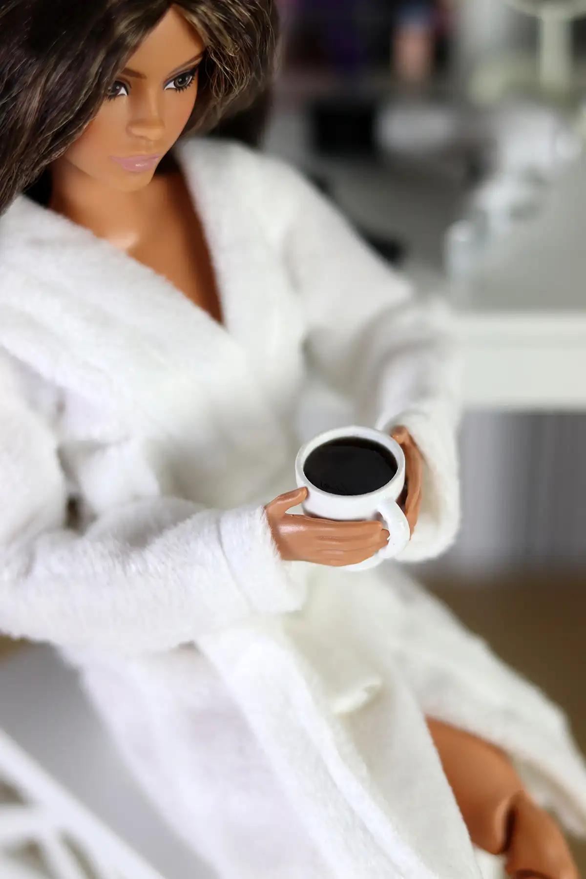 Close-up of Barbie Looks Lina doll holding a coffee cup