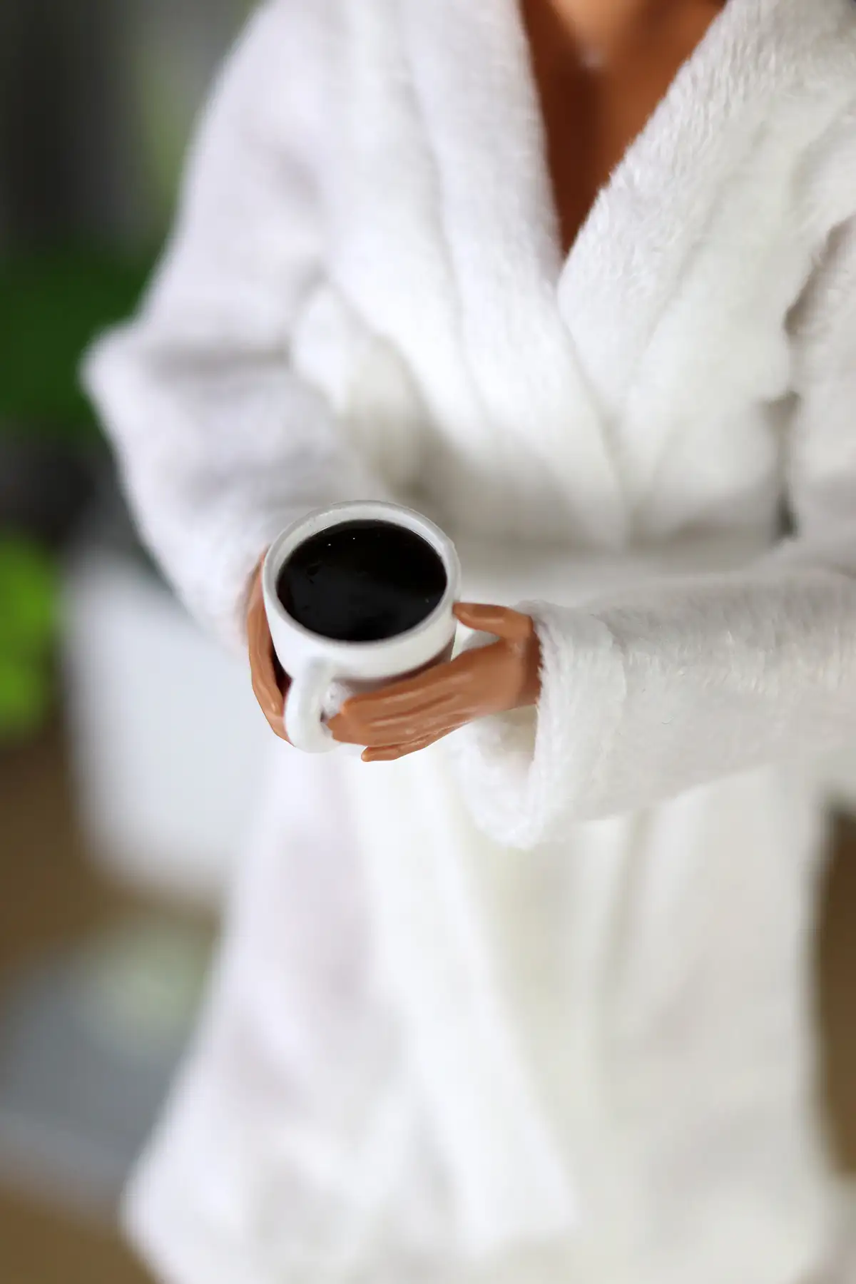 Barbie Looks Lina doll in a white robe with a cup of coffee