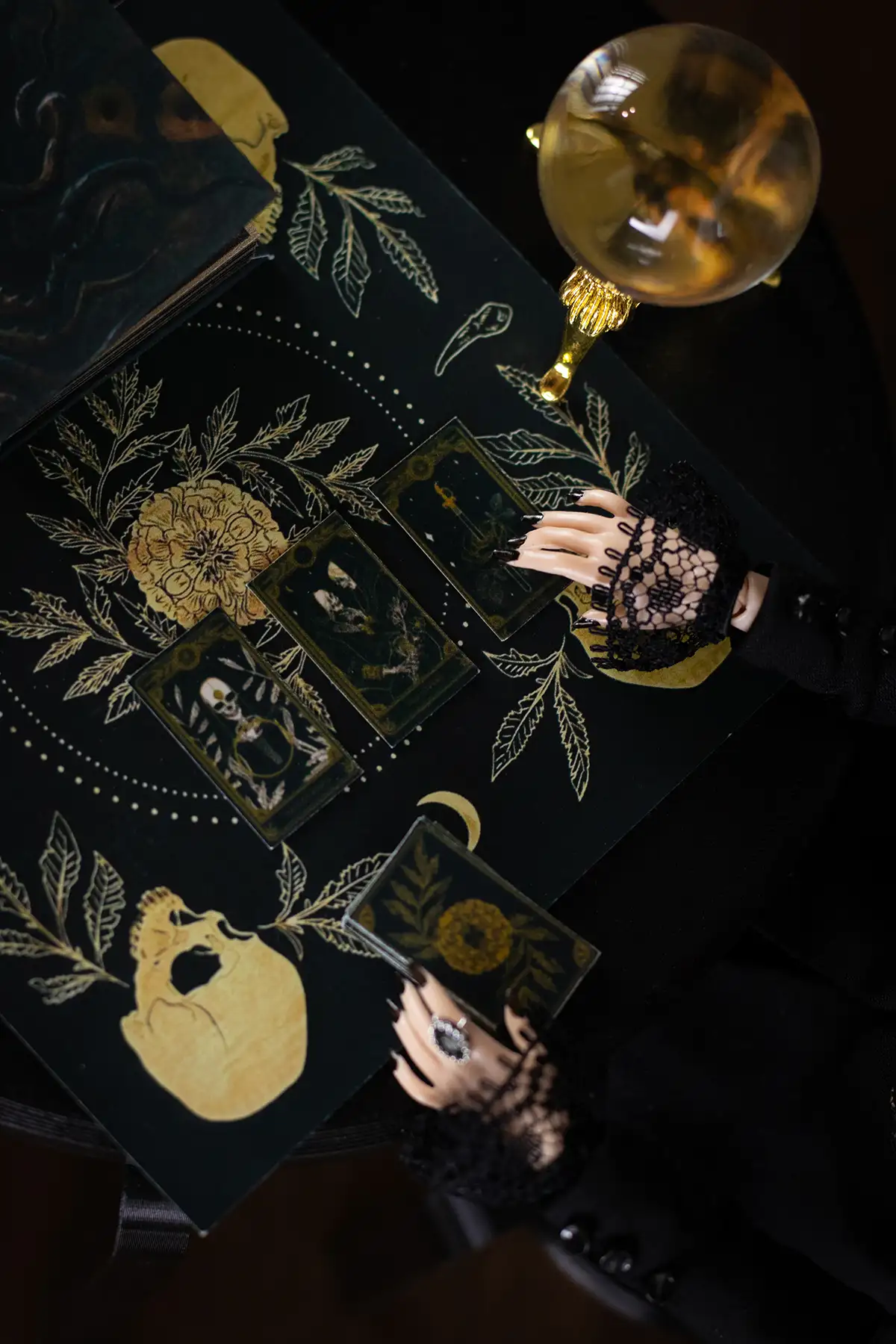 Crystal ball and spellbook on a fortune-telling table viewed from above