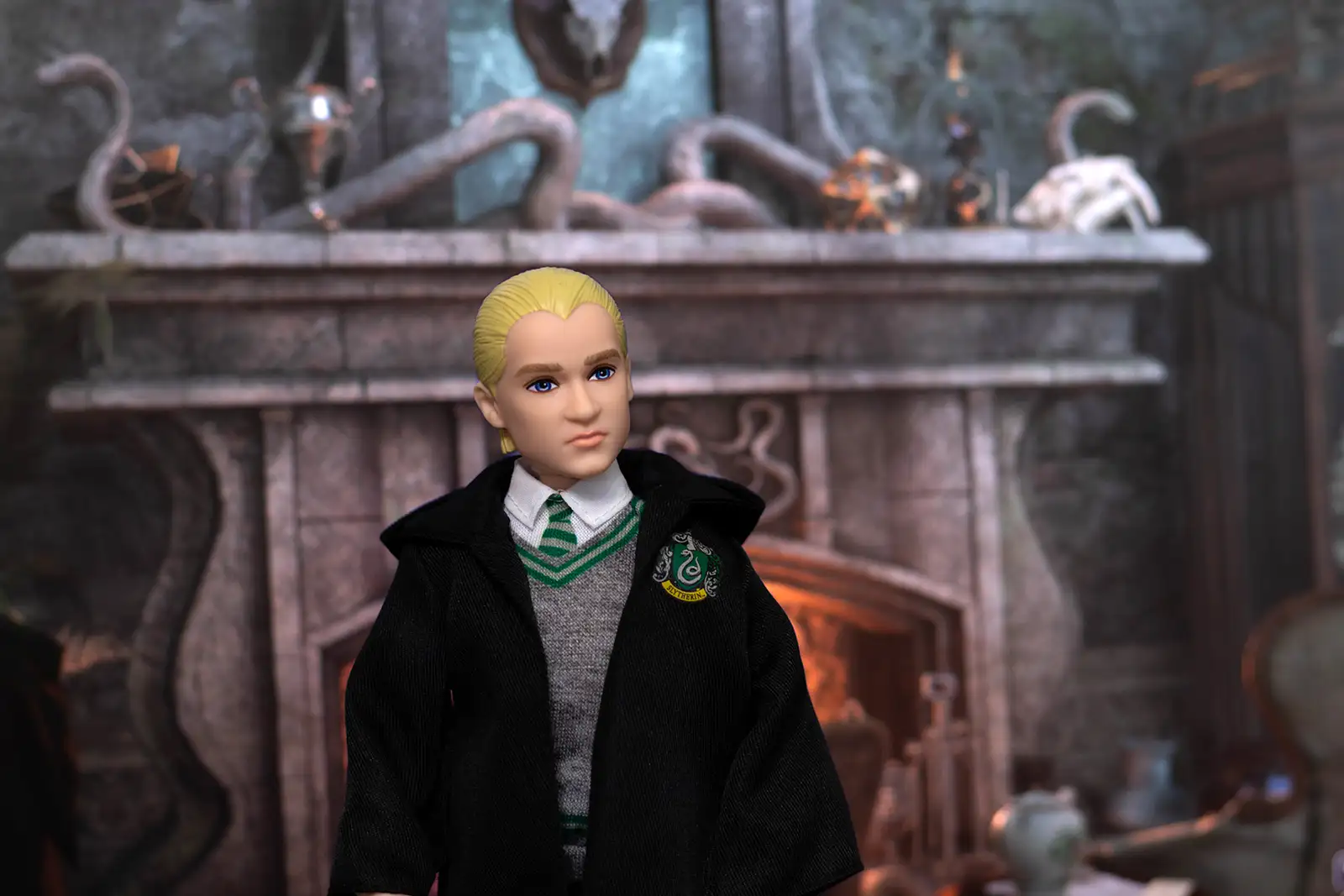 Mattel Draco Malfoy doll posed in the Slytherin common room