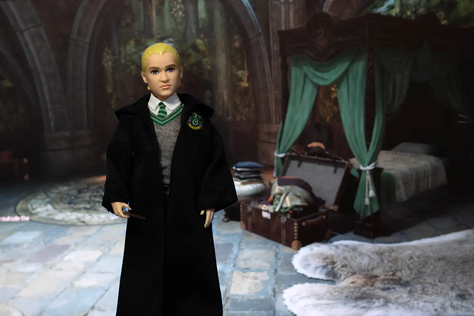 Mattel Draco Malfoy doll in a Slytherin dormitory setting