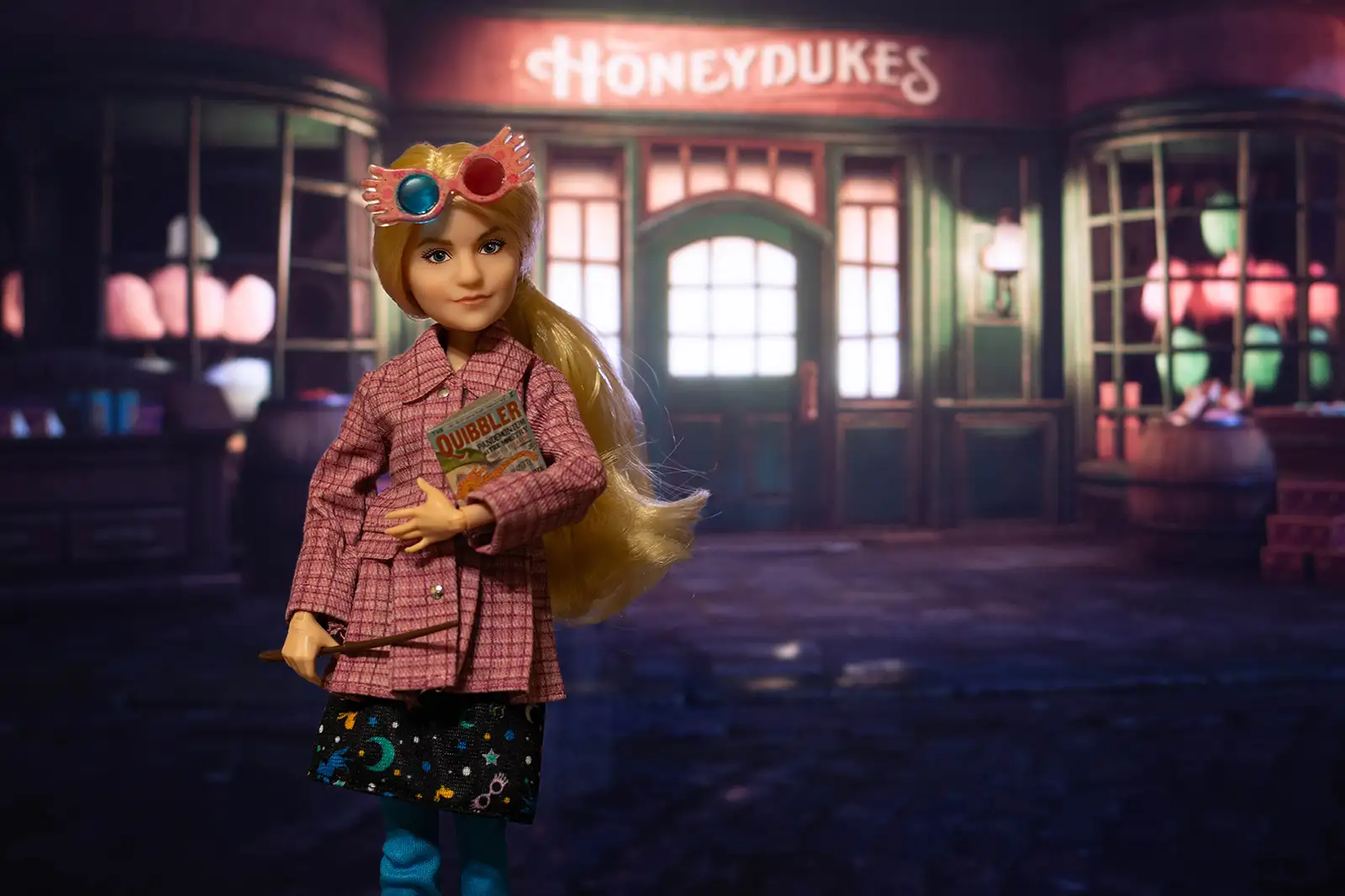 Mattel Luna Lovegood doll outside Honeydukes at night