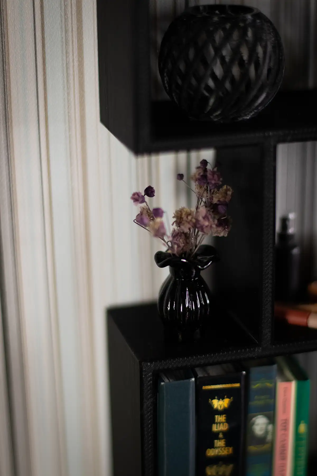 Miniature black glass vase with dried flowers