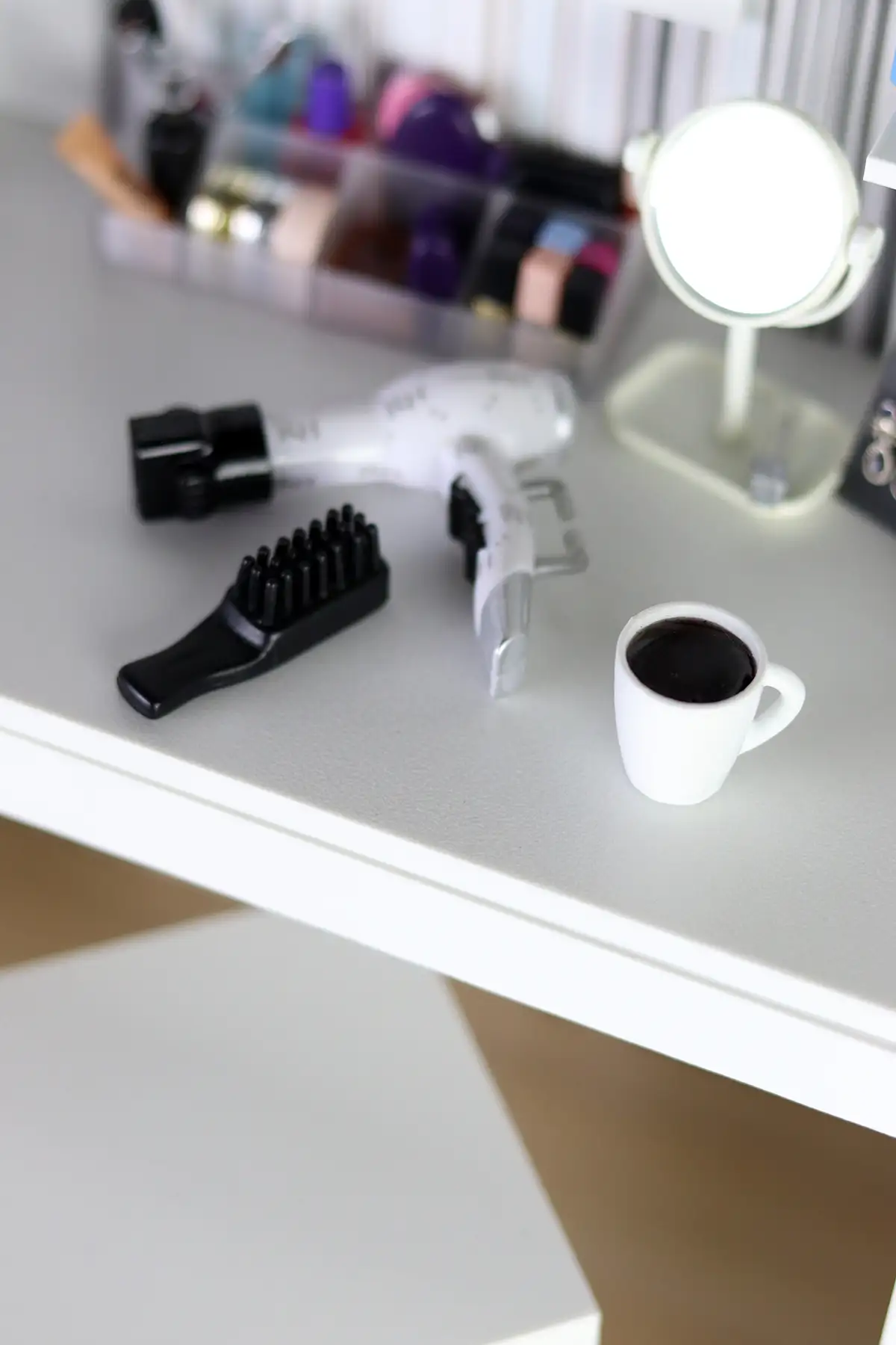 Miniature vanity accessories and a cup of coffee