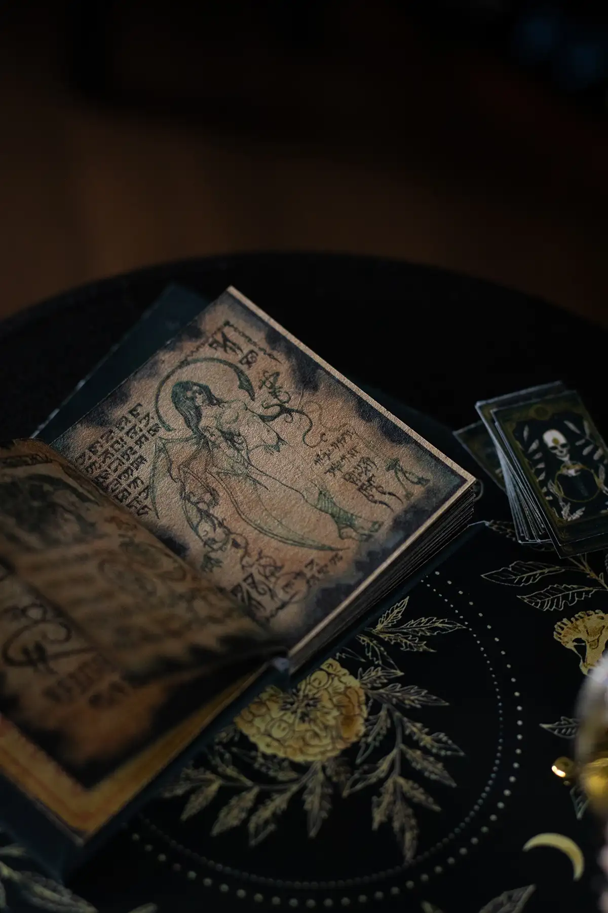 Miniature witch spellbook on a fortune-telling table