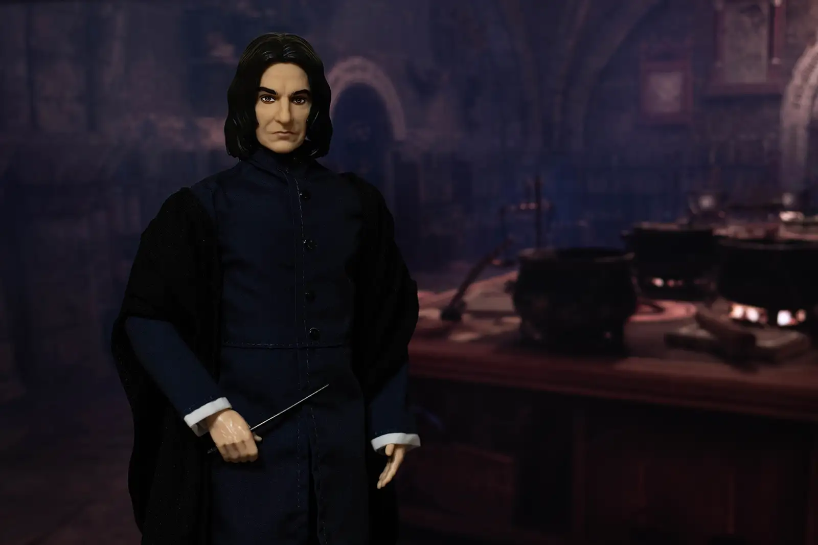 Mattel Severus Snape doll beside the student worktables in the Potions classroom