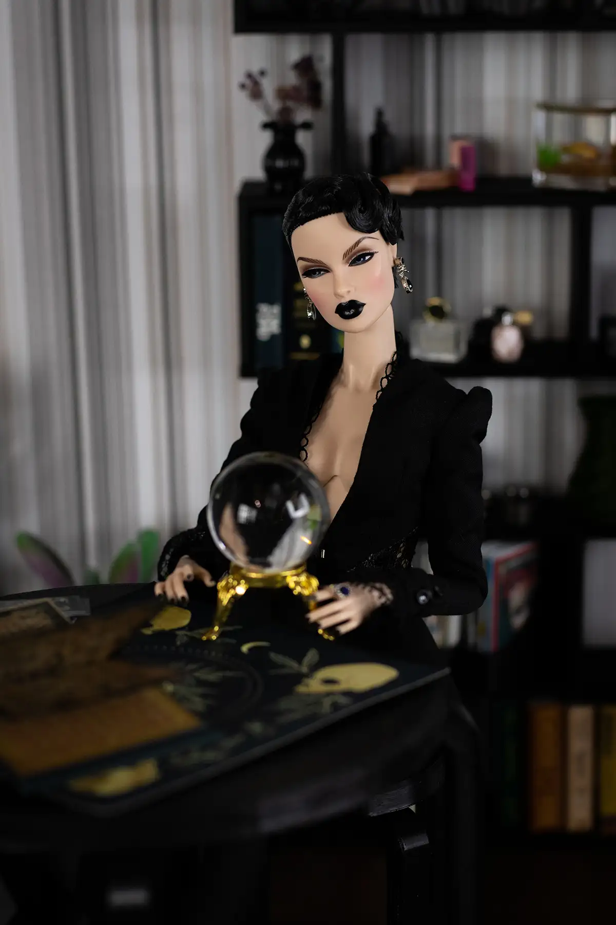 Witch Obsidian holding a miniature crystal ball